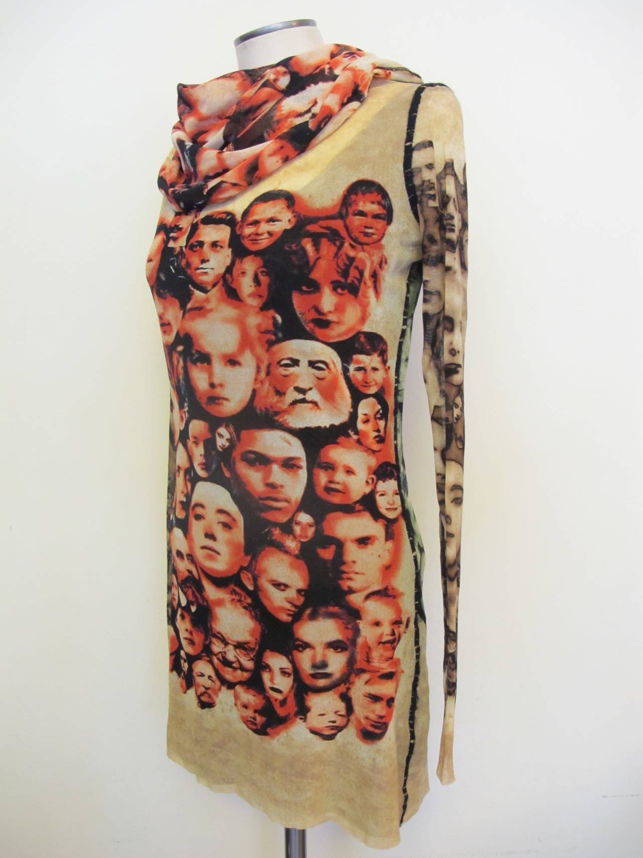 Jean Paul Gaultier Maille Femme Collector's tunic pictures a collage of faces in red tones in the front and a collage of faces in green in the back. The fabric is stretch and has an attached hood. It can be won as a mini-dress. Sleeve length