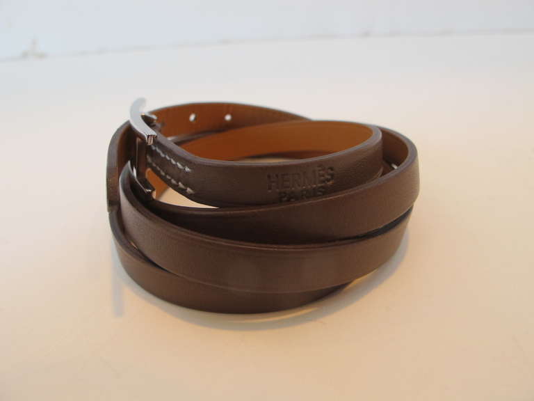 New Hermes Hapi Taupe leather bracelet in original box. Hermes marked on silver buckle and on leather strap. Bracelet wraps around the wrist. Letter 