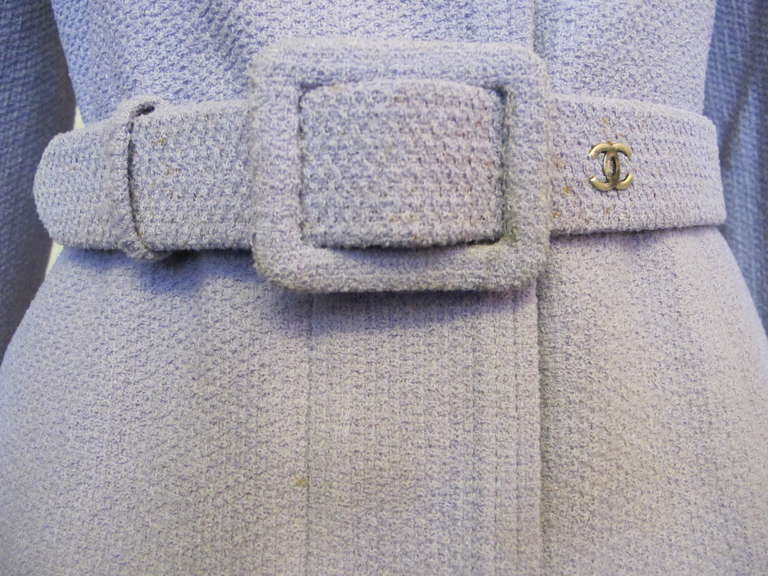 Fabulous Chanel lavender jacket with matching belt with logo on belt. The jacket has hidden pant of the buttons. The wool fabric lends to a perfect fit on the body. Chanel buttons are hidden under the panel for the buttons. The Bergdorf Goodman