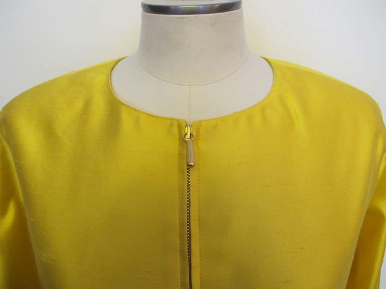 1980's Claude Montana bright yellow suit is highlighted by a zipper in the front of jacket and at sides of sleeves and pockets. The 100% silk tessuto (silk shantung) fabric is divine. The look is crisp and chic.  Skirt length measures 18.25 inches.