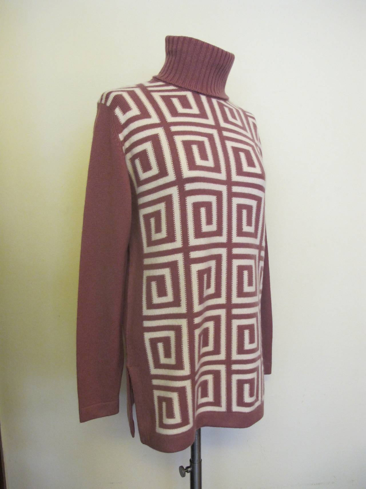 This Ballantyne Turtle Neck cashmere sweater was made expressly for I. Magnin in the 1960's. It is new without tags and the mauve color accentuated by the geometric spiral designs. Colors in sweater is Mauve and White. The Original
I. Magnin Tag is