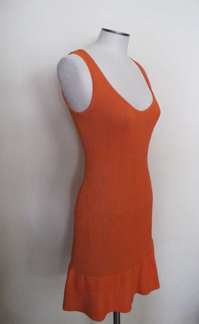 Iconic stretch orange sleeveless dress with designs of vertical lines and 
