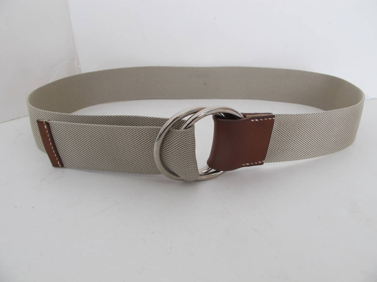 Hermes canvas type belt with silver ring buckle and brown leather. Belt measures 36 inches length (without ring buckle).  Belt measures 1.625 inches in height.
