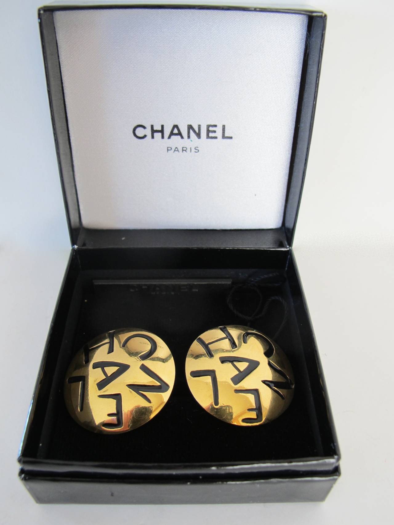 Chic pair of 1970's Chanel earrings featuring Chanel letters. The earrings come with the original box and Chanel tag.