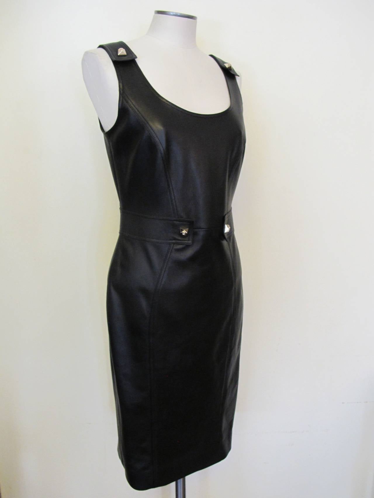 Fabulous navy blue leather sleeveless dress with iconic Versace lining.
There are 4 medusa head buttons - 2 on shoulder and 2 on waist band.
Shoulder to shoulder measures 14 inches.

Original price was $2,975.00
Helpers price is $1,550.00