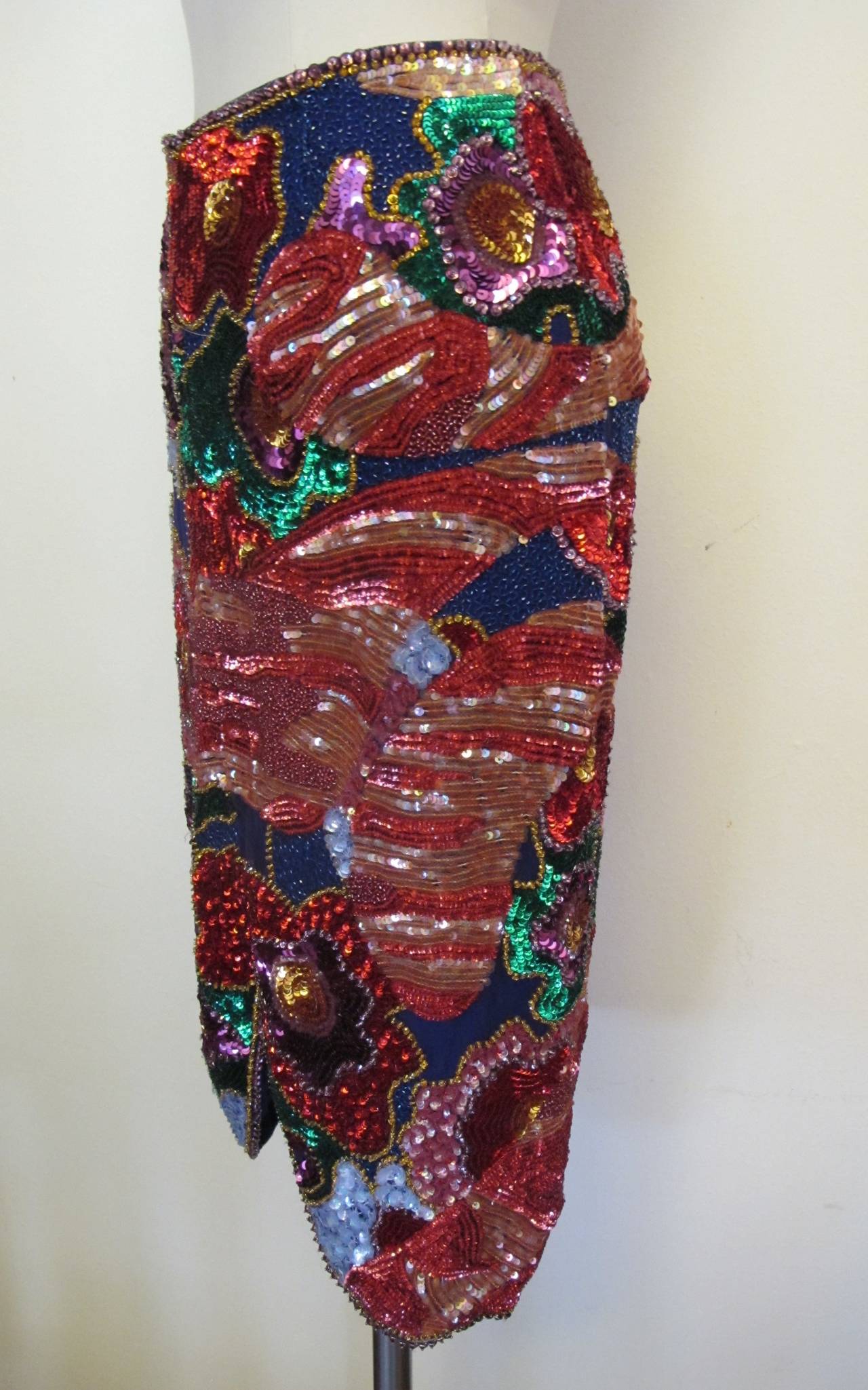 This luscious multi-colored beaded sequin skirt retailed for $8,670.00. The floral design is encrusted with vibrant colors: royal blue, emerald green, shocking pink, purple, melon and gold. There is a space of bugle beads in the back of skirt.