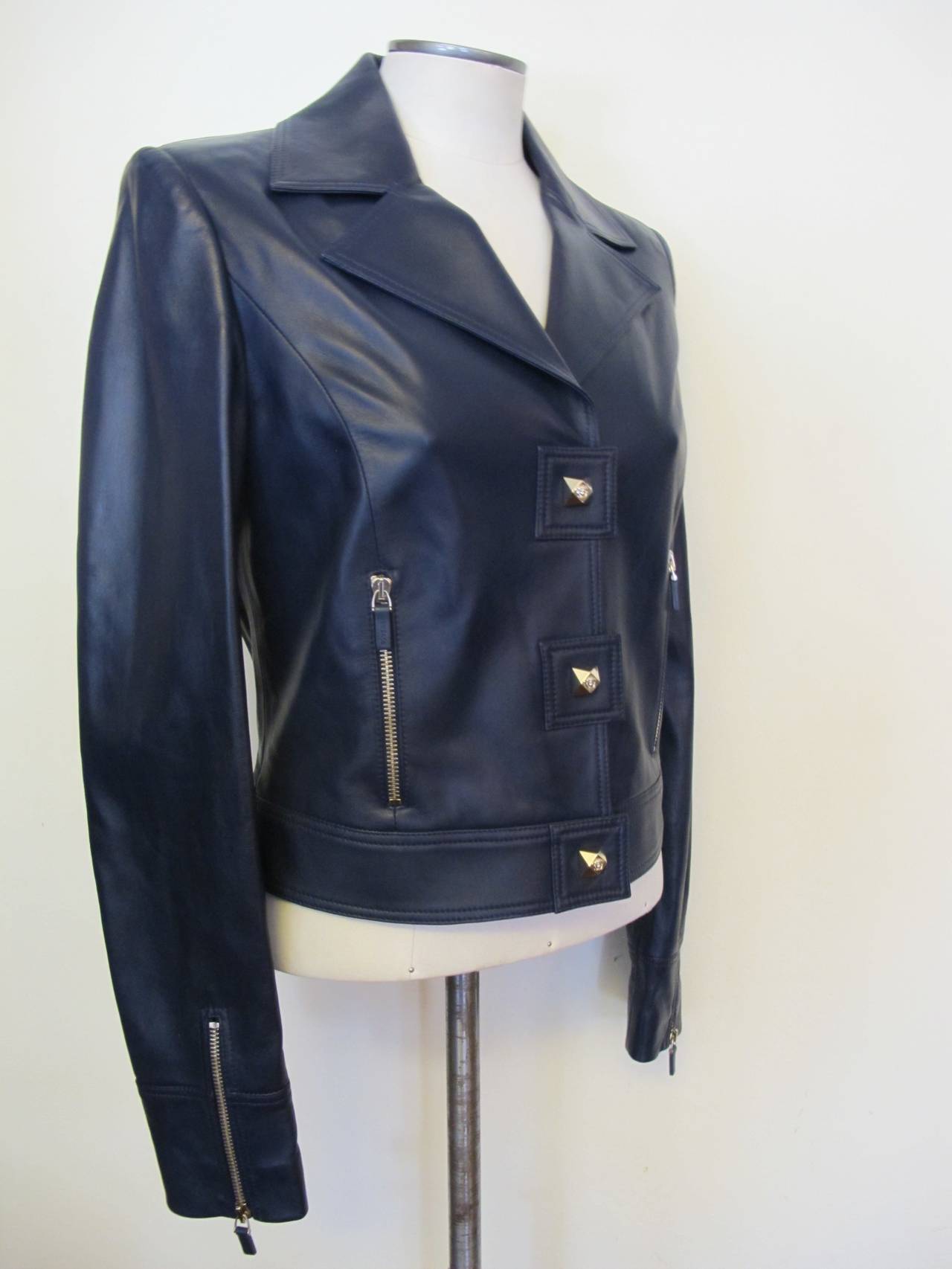This is an exquisite navy leather jacket. It has two - five inch zipper pockets in front of jacket and two matching 5 inch zippers which open sleeves. The Jack is lined with iconic 100% silk Versace lining. The lambskin is very soft.

Shoulder to