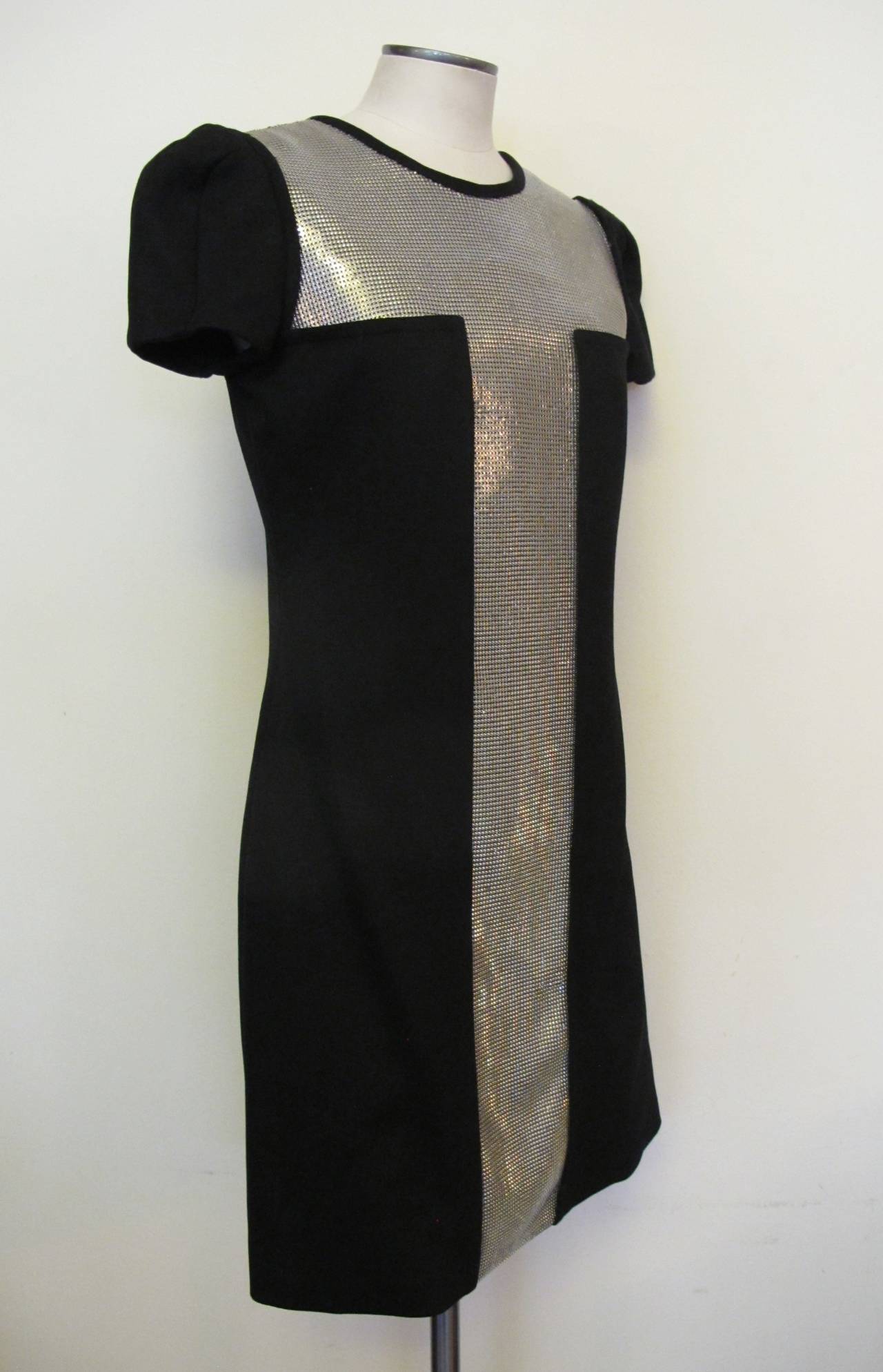 This elegant, chic Versace dress was a hit on the 2013 Runway. The short sleeve dress is embellished with silver metal mesh.

Shoulder to shoulder measures 15 inches. Sleeve length measures 7.25 inches.