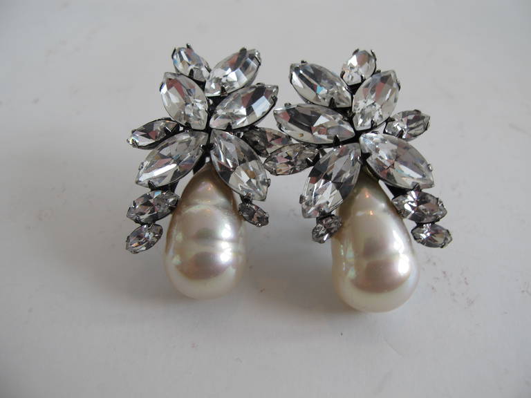 Collectable Iradj Moini faux pearl and rhinestone earrings. The magnificence of the workmanship contributes to the elegance, substance and beauty of these rare statement earrings. Signed by Iradj Moini.