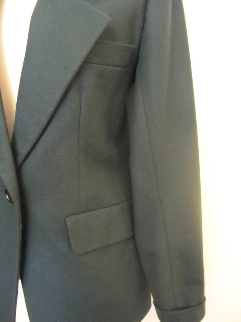 This Yves St. Laurent Hunter Green Jacket fits perfectly. The tailoring is perfection. There are three buttons on each sleeve enhancing the single breasted jacket. Sleeve Length is 23 inches. Shoulder to shoulder is 15.5 inches.