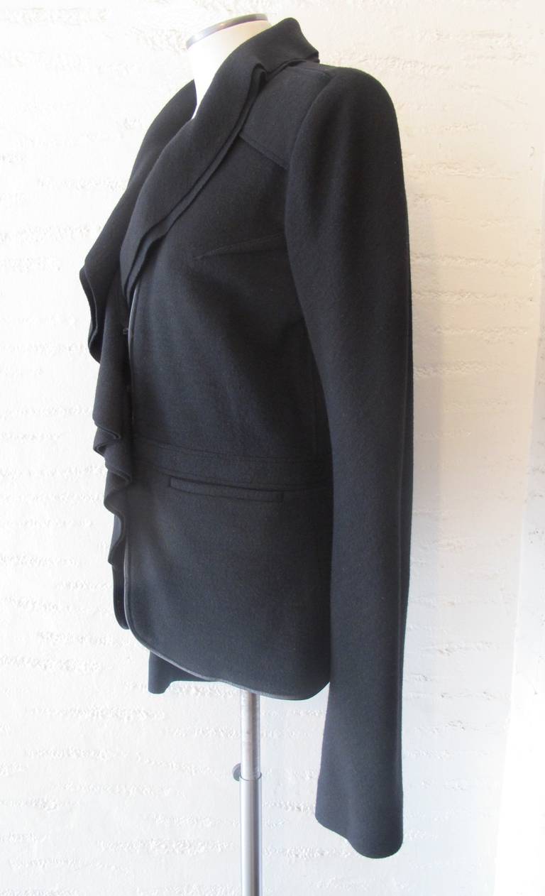 Stunning Givenchy Luxurious Wool Jacket with leather trim and epaulettes. The collar continuously drapes from the bust to below the waist. The jacket has two unopened pockets. It is part of the collection of a former Fashion Director of Saks Fifth