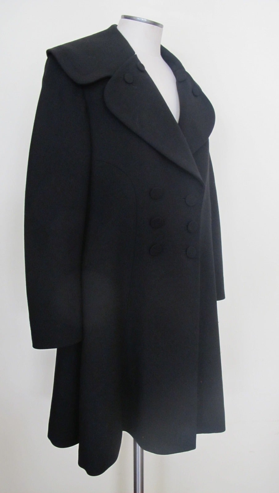 Elegant, chic Alaia Wool Coat with Semi-Shawl Collar. 2 Columns of 3 covered buttons on each side adorn the front of the coat, 2 covered buttons on each lapel. The coat fits the body to perfection. Sleeve length measures 22.5 inches. Shoulder to