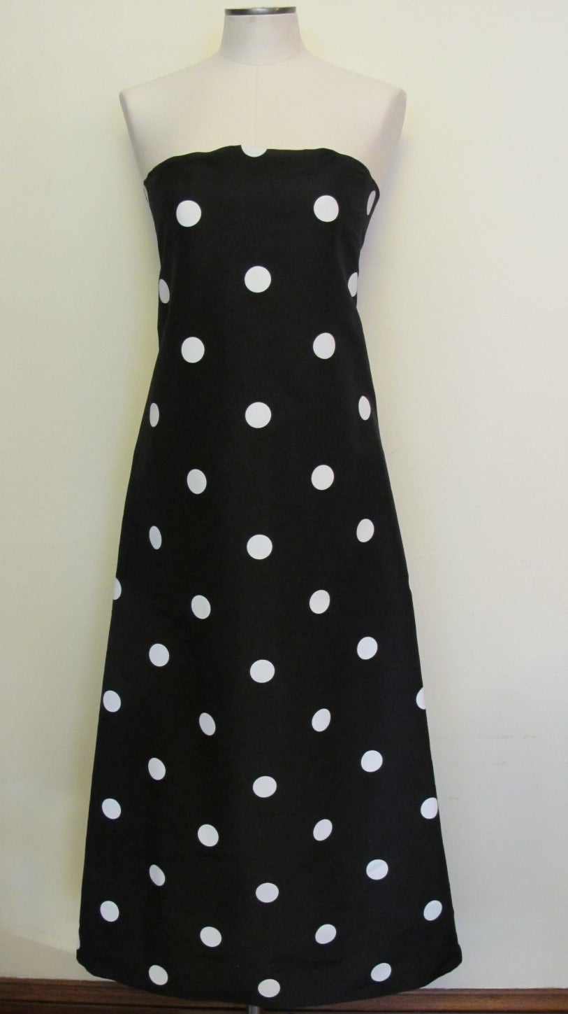 Strapless Black Silk Taffeta Gown with White Polka Dots. The Dress is an entrance gown which hugs the body. It is shorter in the front - the back of the gown is longer and has a feeling of a mermaid small train. Front of dress measures 44 inches