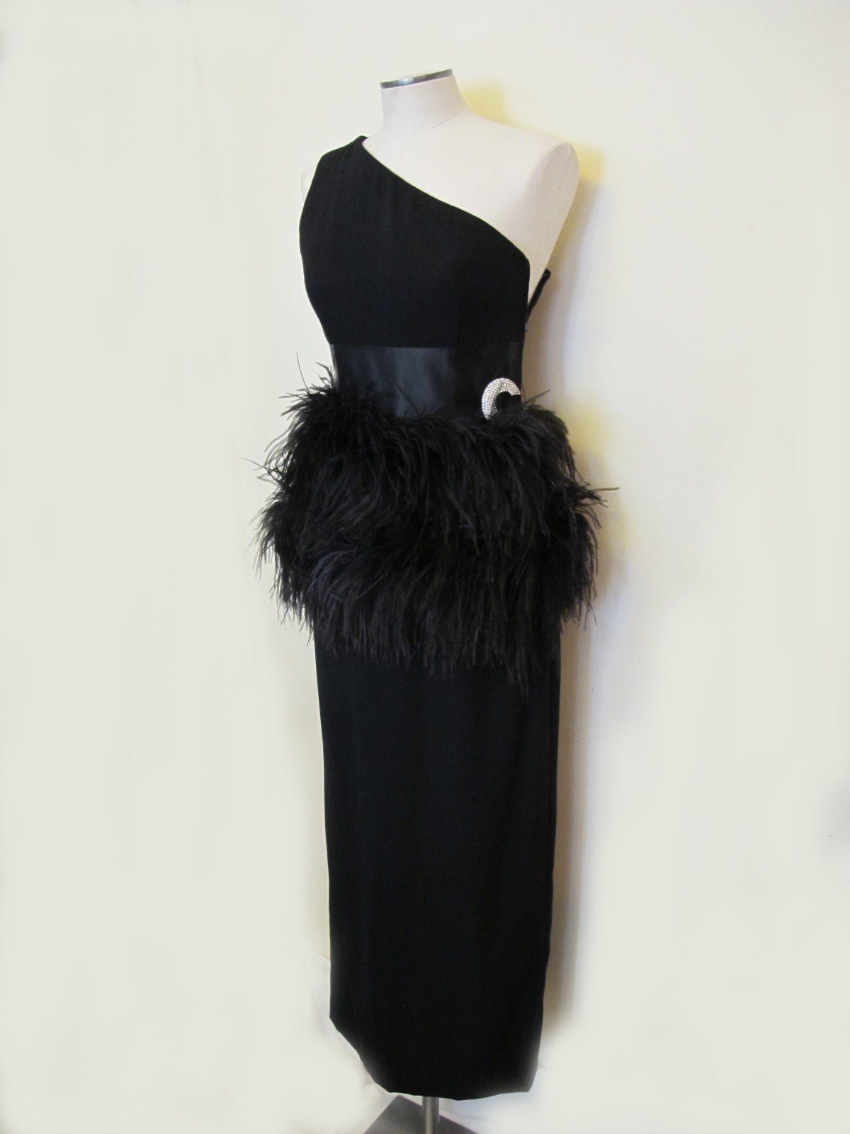 Iconic Carolyn Roehm Black Evening Gown with Black Ostrich Feathers and 3.75 inch band of satin beginning at waist. Glamorous socialite Carolyne Roehm worked 9 years as an assistant to Oscar de la Renta. She introduced her first collection under he