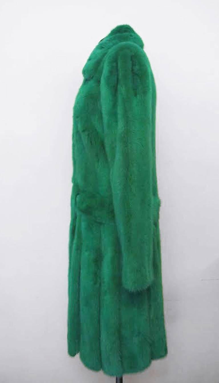 The original retail price was $35,795. This Gianni Versace coat from the Fall/Winter 2012 Runway collection is brought to life via the quality of the mink, the design of the electric green coat and the electric green color. It is lined in green