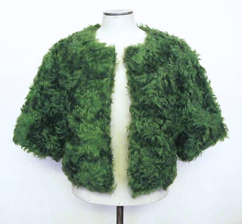 Prada green mohair bolero with hook closures. The bolero is ever so chic and can be worn during the day with jeans or in the evening with a cocktail dress or gown.