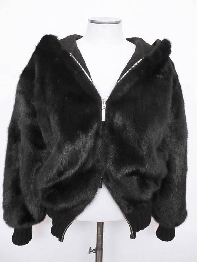 This 2012 Gianni Versace double blouson mink jacket is an unusual piece which retailed for $30,085.00. The original tag remains on the jacket. When on the body, it is chic and warm because of the cashmere lining of the jacket and hood. It is
