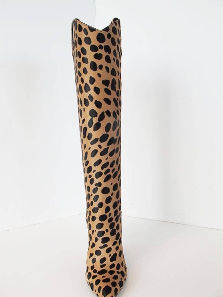 These over the top  2013 Tom Ford cheetah boots with gunmetal heels were originally $2,790.00. They are made of cheetah printed pony hair and are 
19.50 inches high with 4 inch heels.  The throat of the boot is black suede with silk