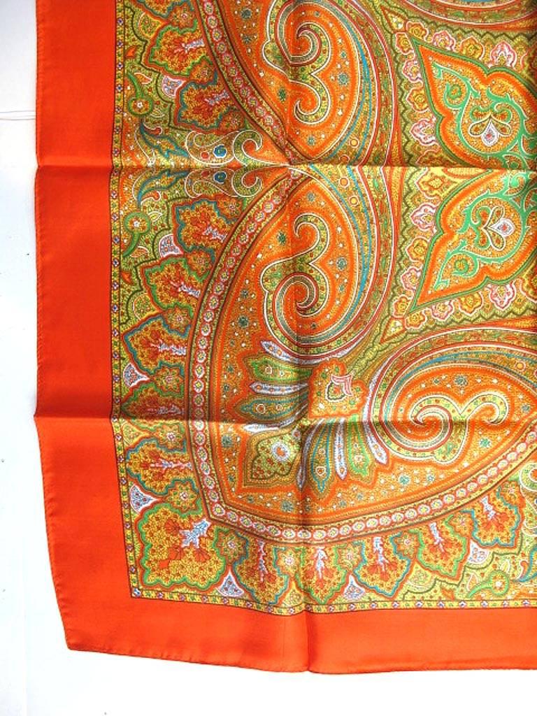 This beautiful Liberty of London electric orange scarf has a stunning paisley print motif. It is 100% silk and was made in England. It came to us via a grande dame's estate in Hillsborough, California. It measures 27x27 inches.

* Your purchase
