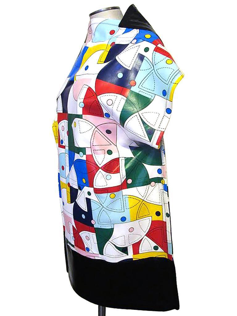 This Spring 2015 abstract asymmetrical tunic by Junya Watanabe has a bright primary colored geometric print is 100% polyester. The piece is bordered with black synthetic leather. There is zig zag stitching accenting the seams. This art piece was