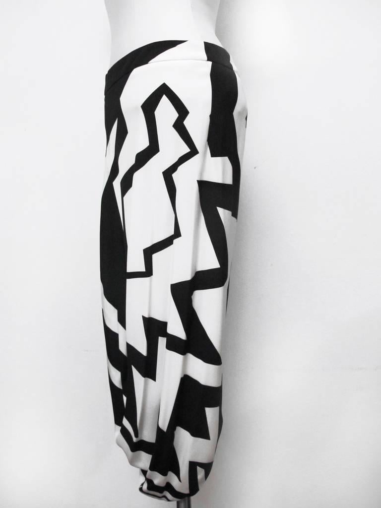 This fabulous fall 2013 runway Tom Ford harem skirt has an eye-catching chalk and black geometric print. It falls into a dramatic drape in the front and comes up into a high slit in the back. The skirt is 100% silk and so is the full lining. It was