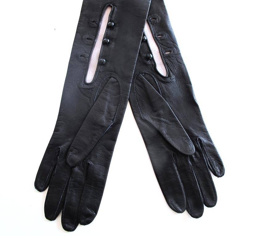 These elegant Akris of Paris evening gloves are created in black leather with three buttons serving as closures at the wrist on each glove. The leather is quite soft and they are in excellent condition with tags attached.

YOUR PURCHASE BENEFITS