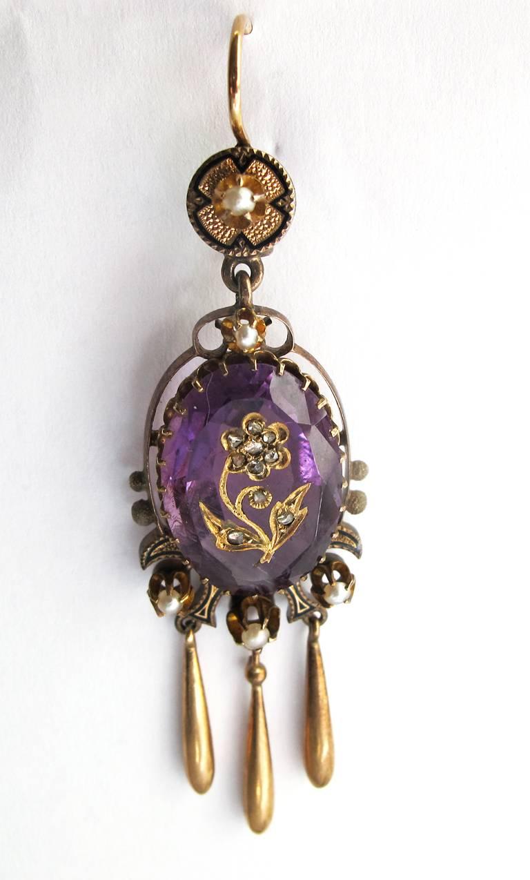 These very rare Victorian amethyst and 14k gold pierced earrings are from the collection of the famous interior decorator Frances Elkins. The amethyst stones have a flower motif carved in them with rose diamonds inset. Genuine natural pearls accent