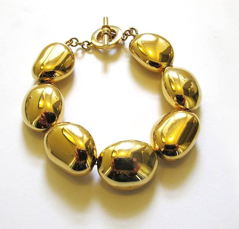 This chic Ralph Lauren bracelet is made up of pebble shaped beads in a heavy shiny metallic gold-tone. It is nine inches long and the beads are one inch in diameter.

YOUR PURCHASE BENEFITS THOSE WHO ARE DEVELOPMENTALLY DISABLED.