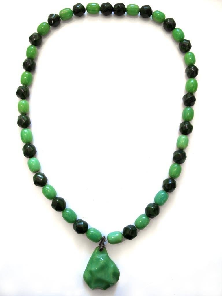 Vintage 1960's light jade green and forest green Bakelite beaded long necklace has a pear-shaped textured pendant. The piece is from the collection of a Grande Dame of Hillsborough, California.

YOUR PURCHASE BENEFITS THOSE WHO ARE DEVELOPMENTALLY