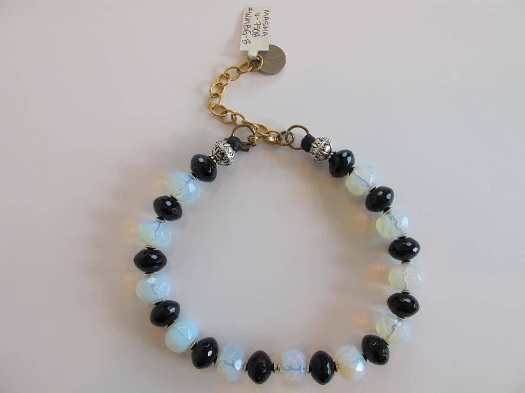 New Masha Archer single strand necklace of faceted white opalite milk glass and black glass rondelles (from China). Stamped rondelle end beads of pewter (from India). Plus plated furnishings and two-sisters men's pocket watch clasp. Ending with 1977
