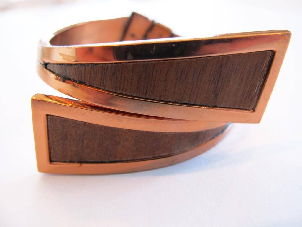 Vintage 1950's Renoir wood-grain clamper bracelet. The piece is in a modernist design of copper with wood-grain veneer insets. Signed.

YOUR PURCHASE BENEFITS THOSE WHO ARE DEVELOPMENTALLY DISABLED.