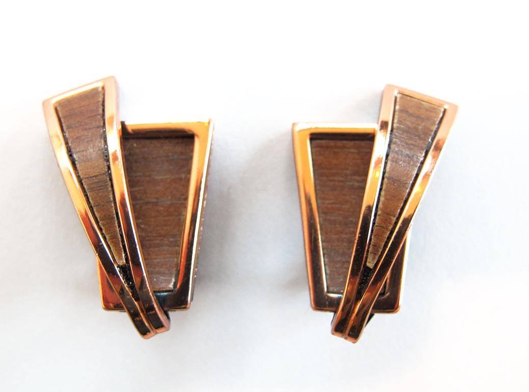 Vintage 1950's Renoir clip-on earrings. These earrings are in a modernist design of copper with wood-grain veneer insets. Signed.

YOUR PURCHASE BENEFITS THOSE WHO ARE DEVELOPMENTALLY DISABLED.
