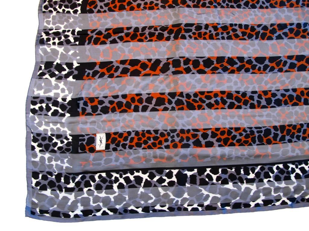 Vintage 1980's Yves Saint Laurent 100% silk scarf/wrap in tones of brown, black, white and burnt orange with a striped leopard print design. Hand sewn and rolled edges. Signed.

YOUR PURCHASE BENEFITS THOSE WHO ARE DEVELOPMENTALLY DISABLED.