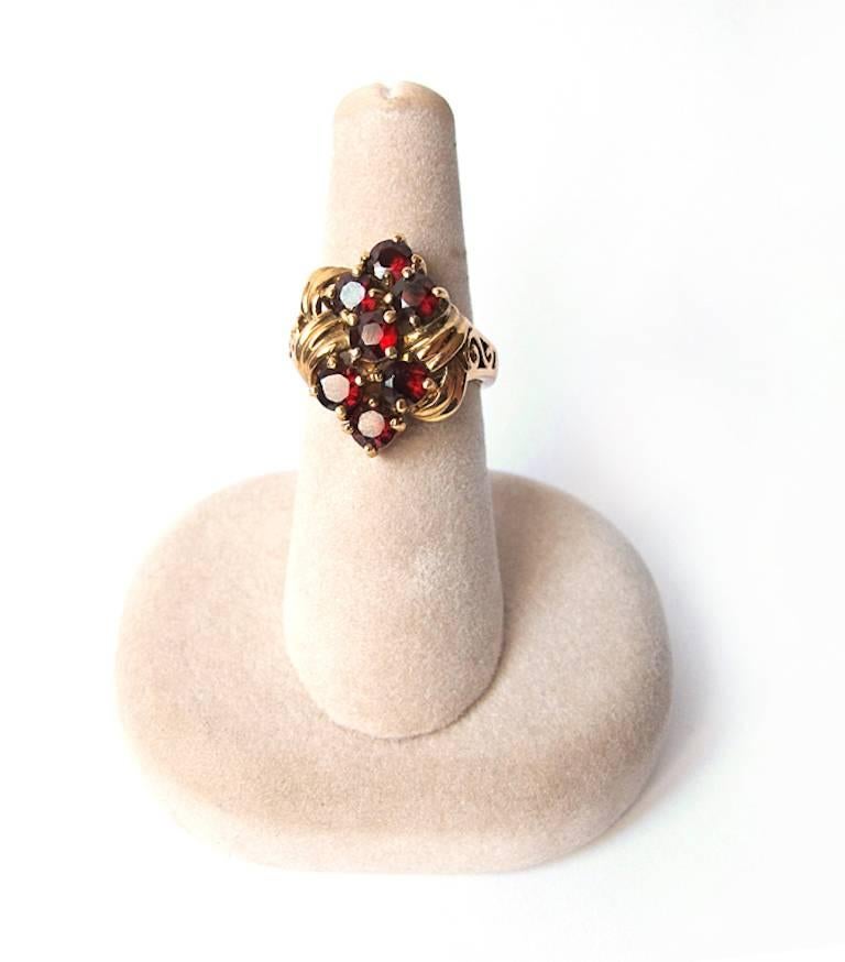 Statement garnet ring has filigree on sides and scallops on sides.

Ring Size: 7

YOUR PURCHASE BENEFITS THOSE WHO ARE DEVELOPMENTALLY DISABLED.
