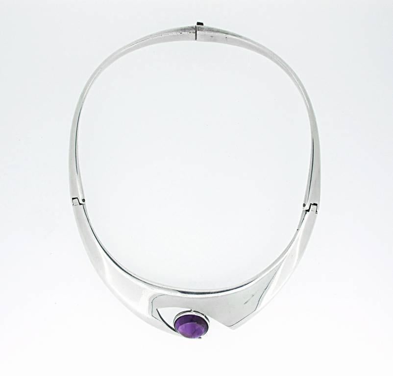 This Taxco vintage sterling silver necklace has an amethyst cabochon within an eye design. Signed by Sigi Pineda. Created in 1940's. Made in Mexico.
The modernist design is bold and beautiful with a strong clasp. It is signed with the makers stamp