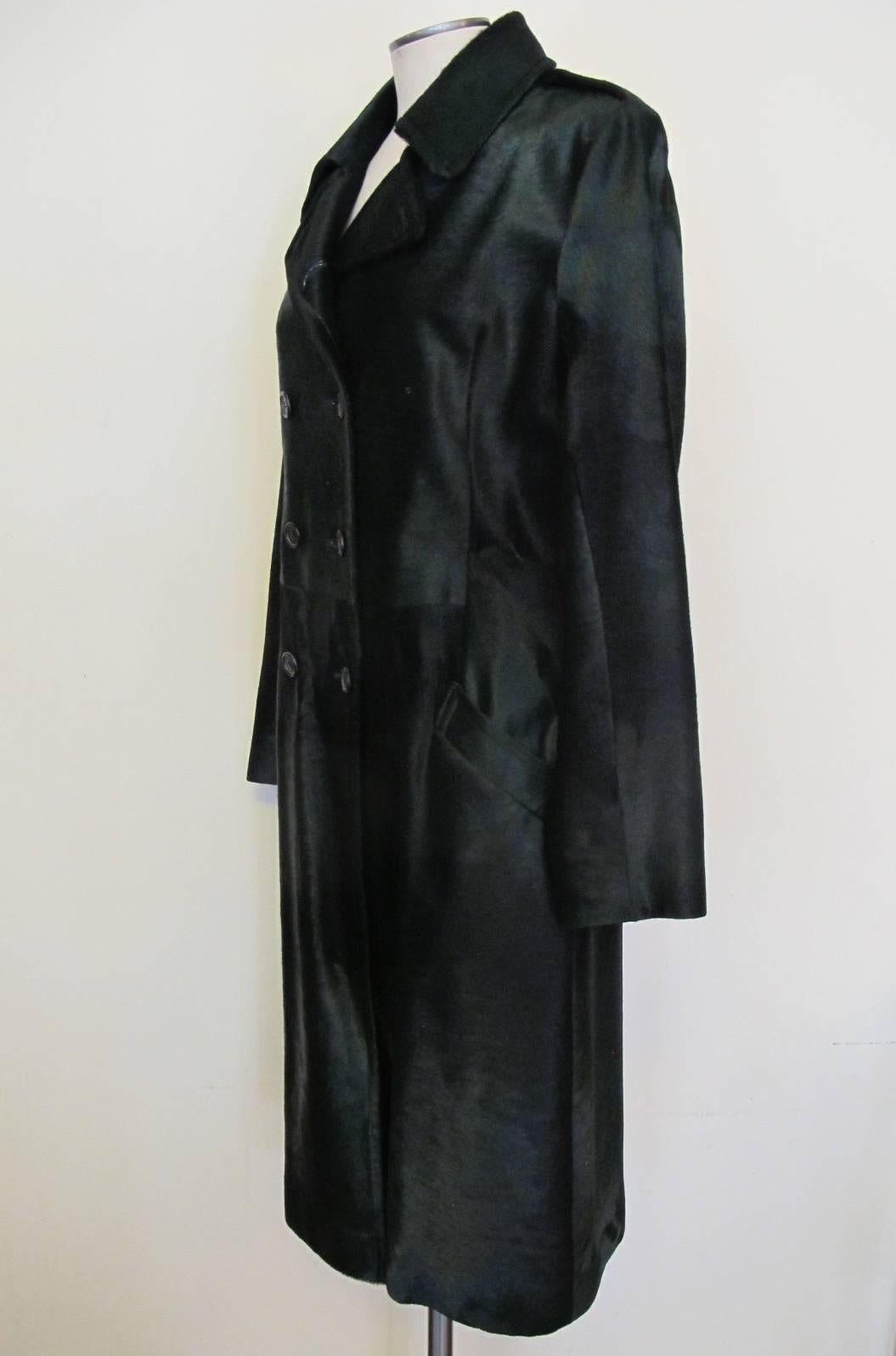 Over the top elegant Prada double breasted forest green calf fur coat with two pockets. Six buttons serve as the panel for the coat. The coat is absolutely stunning! Sleeve length measures 24 inches. Shoulder to shoulder measures 16.5 inches.