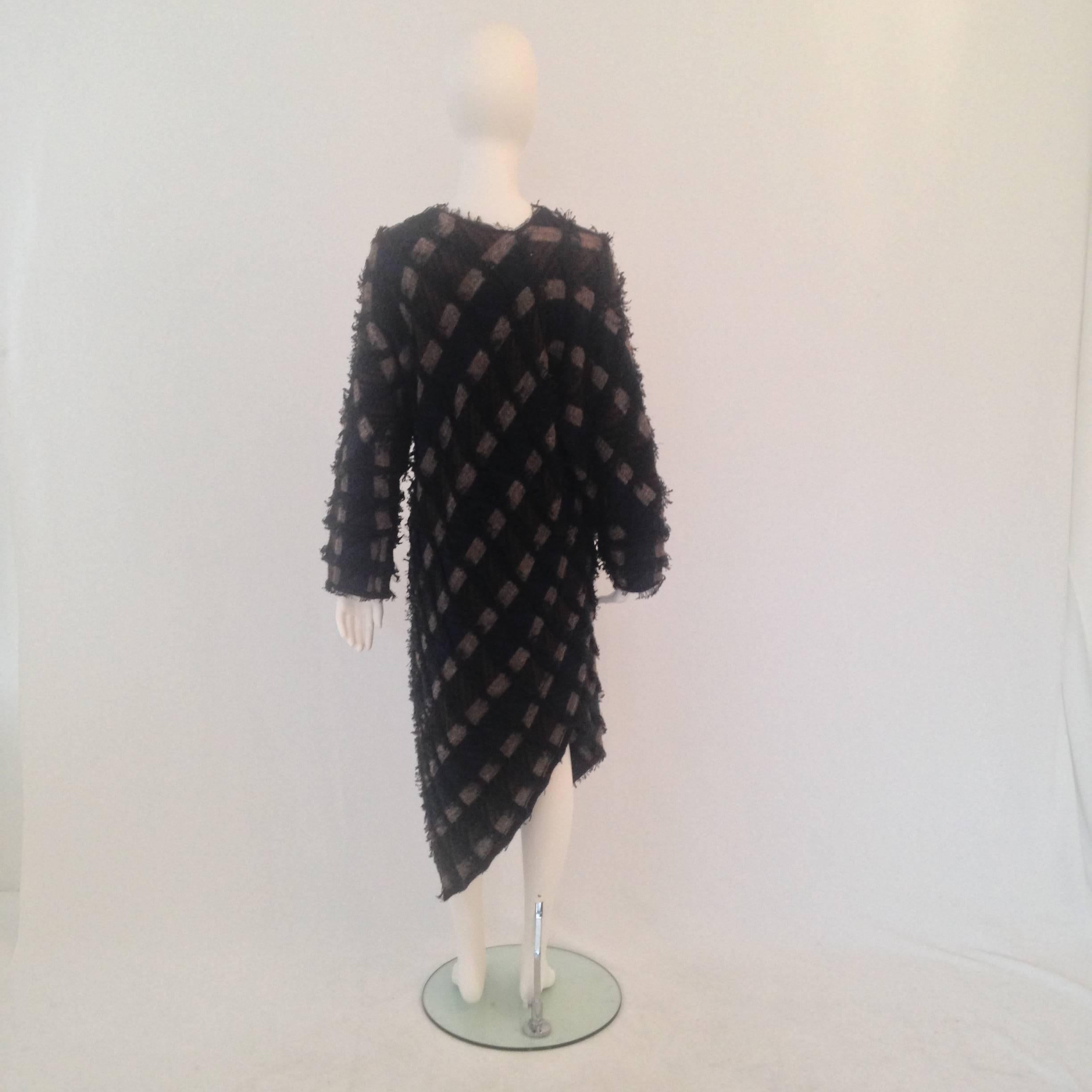 Issey Miyake 1980's knit woven dress features an asymmetrical hemline and slightly oversized fit.