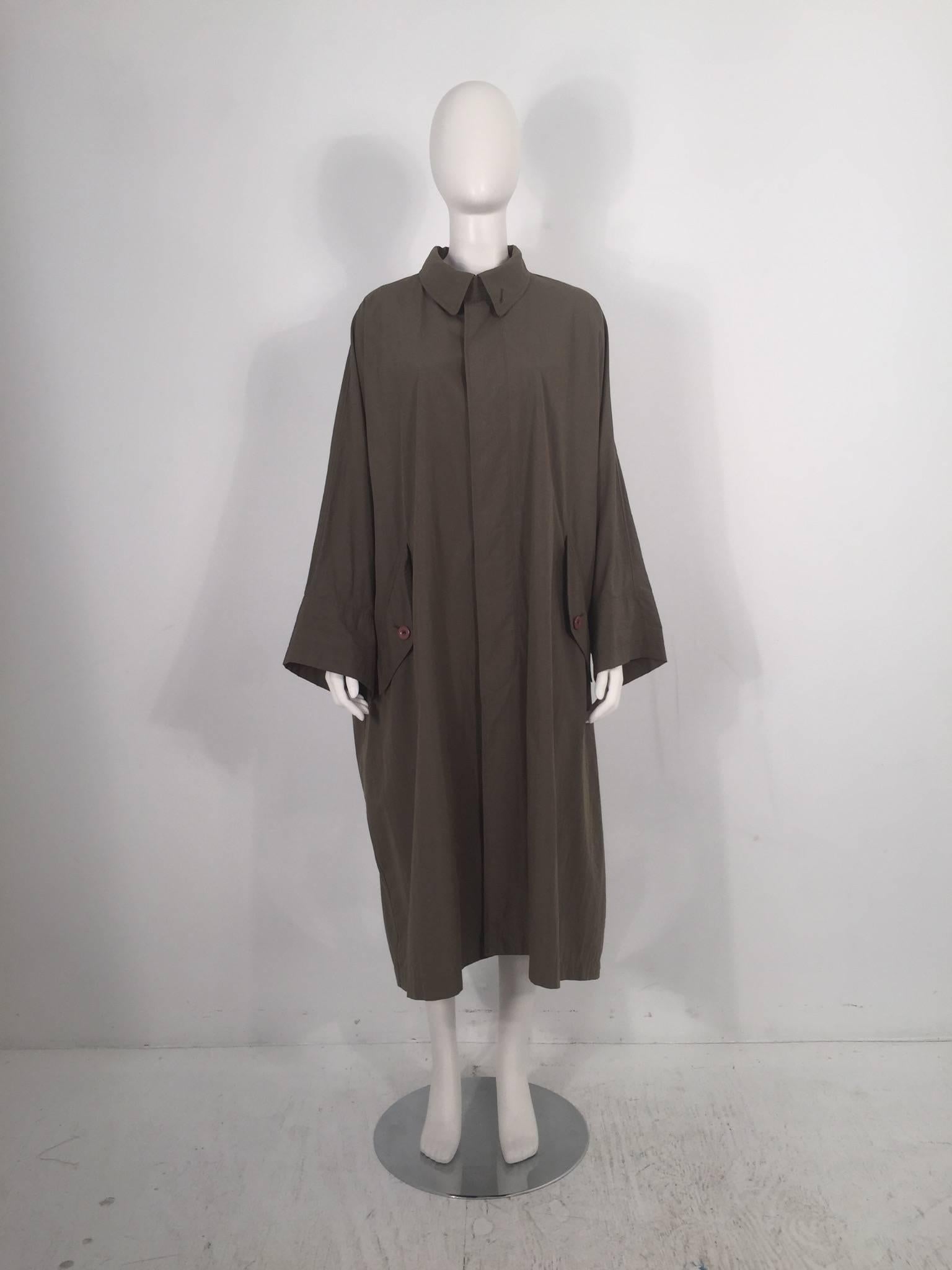 Issey Miyake 1980's windcoat features 24'' sleeves and multi-button closure. 

For International orders, please contact us for a shipping quote.