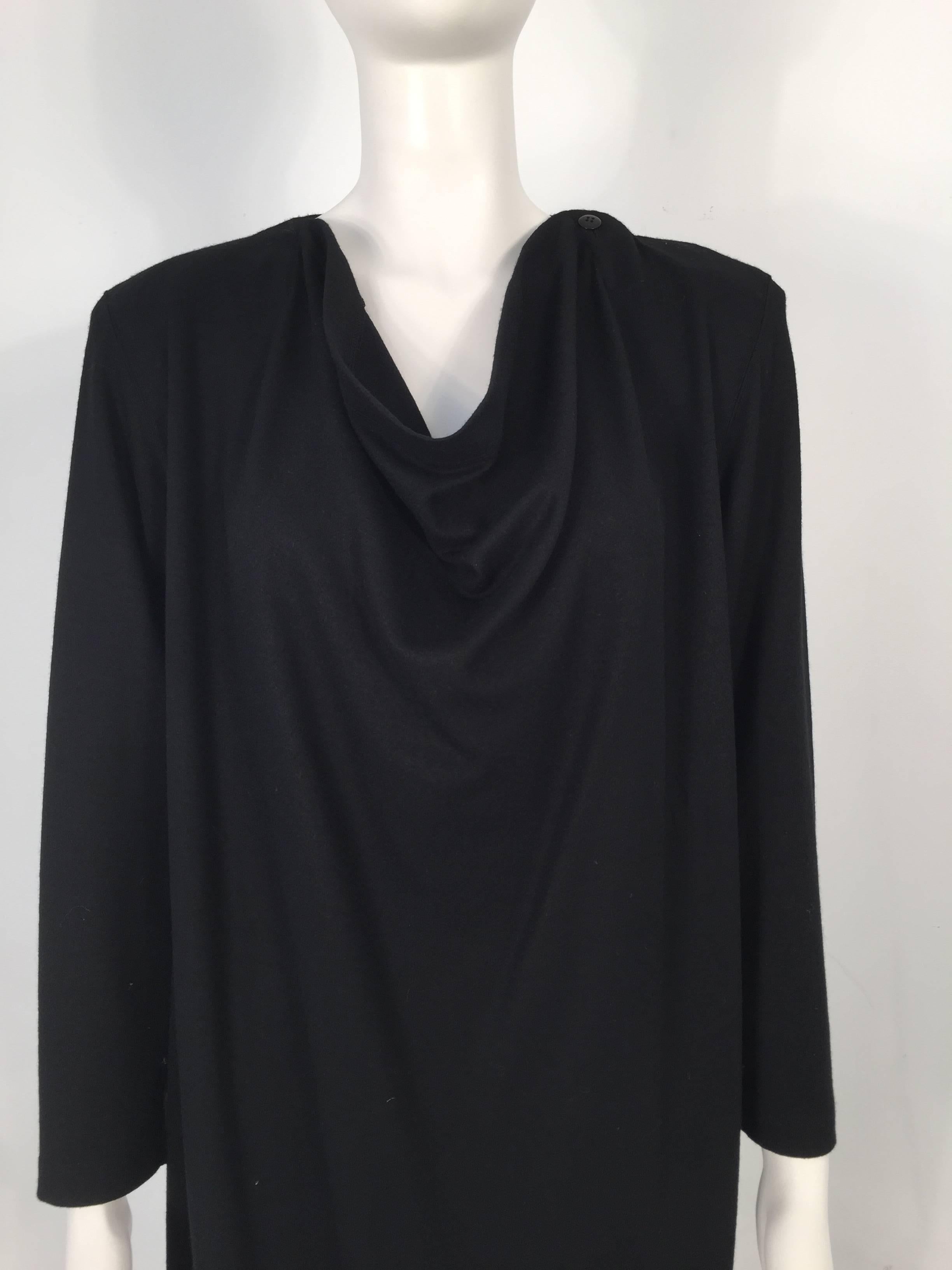 Issey Miyake 1980's black cashmere dress features a brass zipper on the back and a futuristic cut.

Measurements: Sleeves:  23''; Zipper: 19''; Slit: 12''

For International orders, please contact us for a shipping quote.