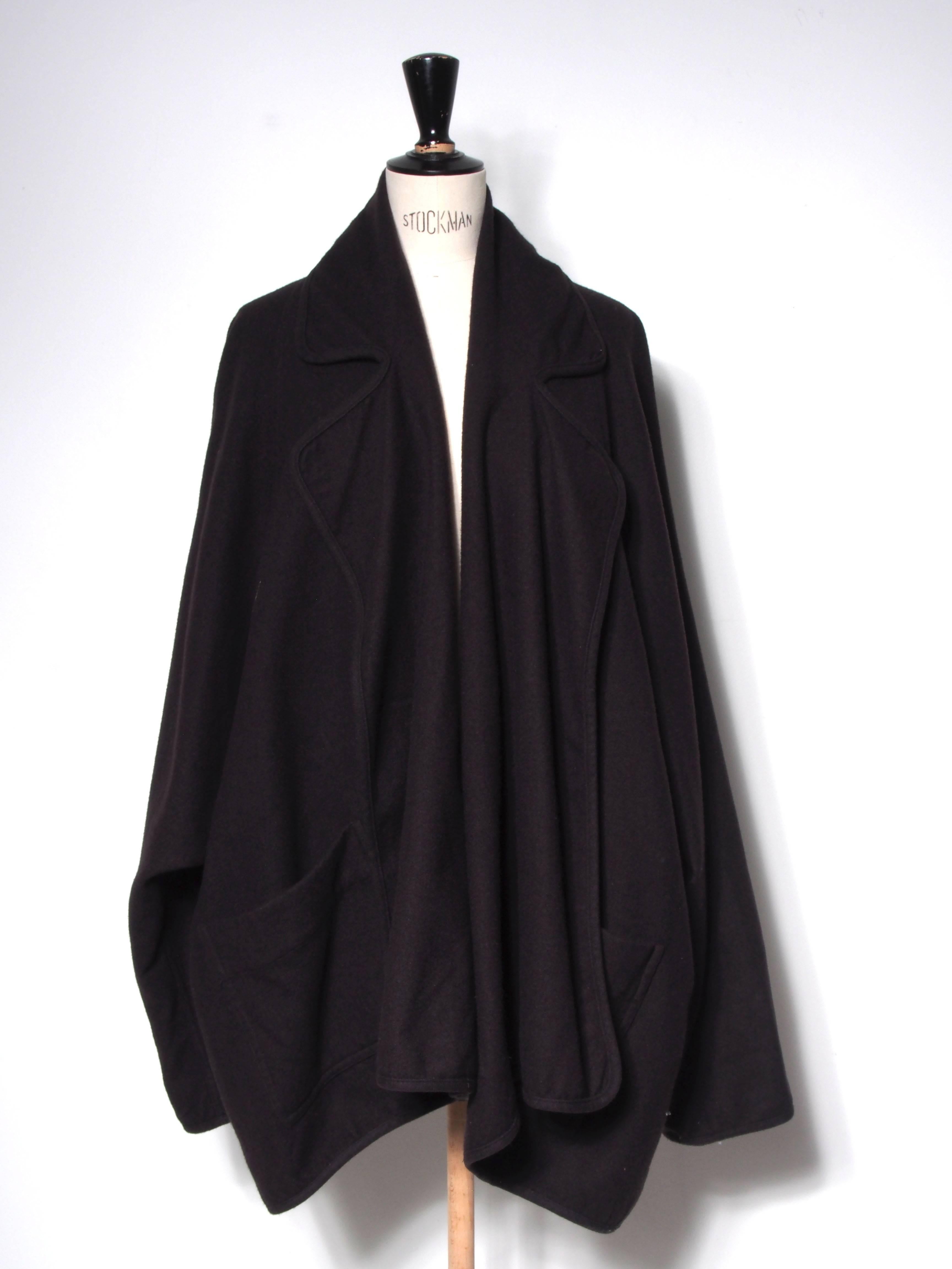 Draped brown wool open front jacket with oversized collar and pockets.