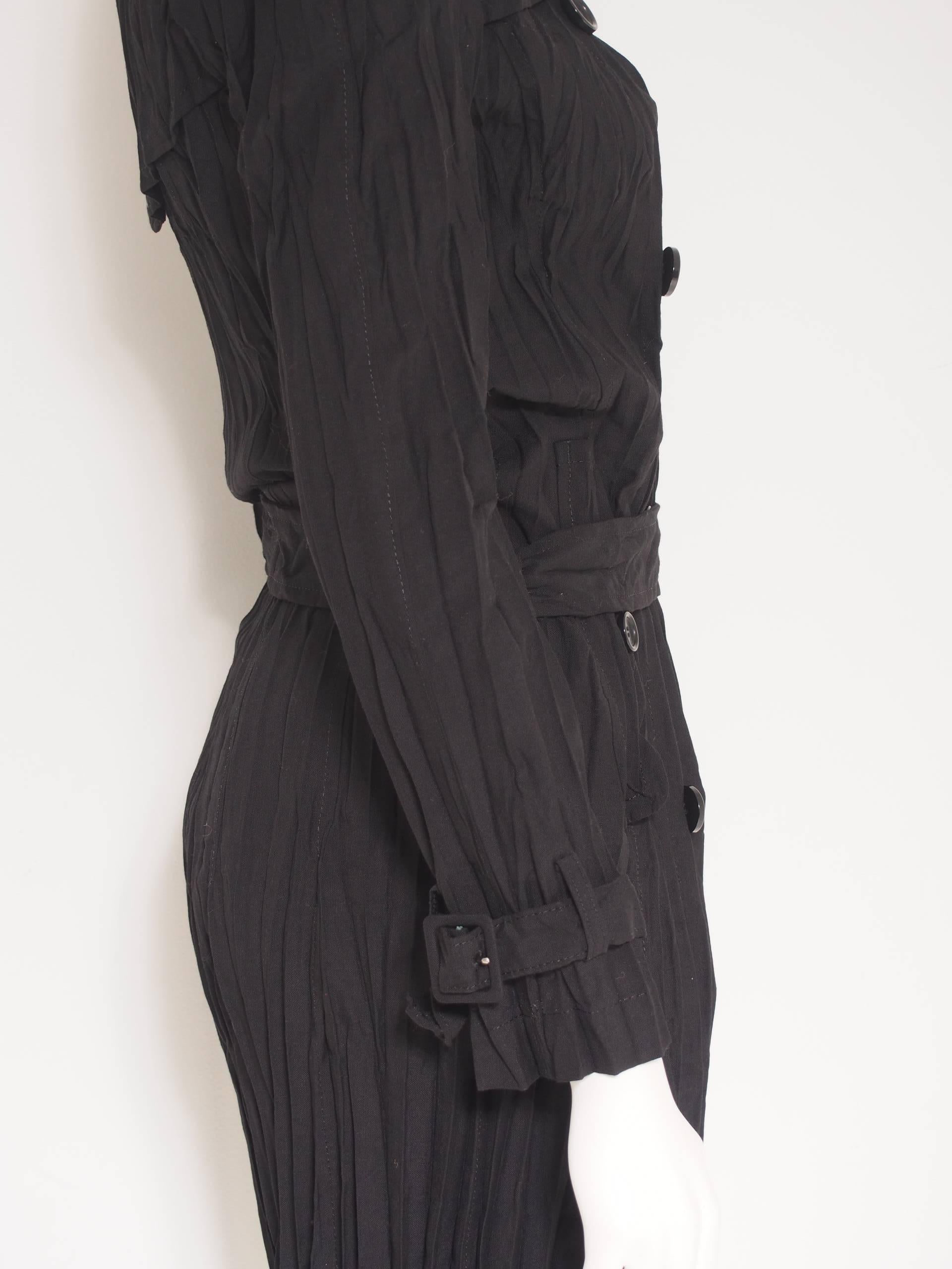 Iconic Junya Watanabe Comme des Garçons fitted, black, belted crinkle jacket with button closure and epaulet details.