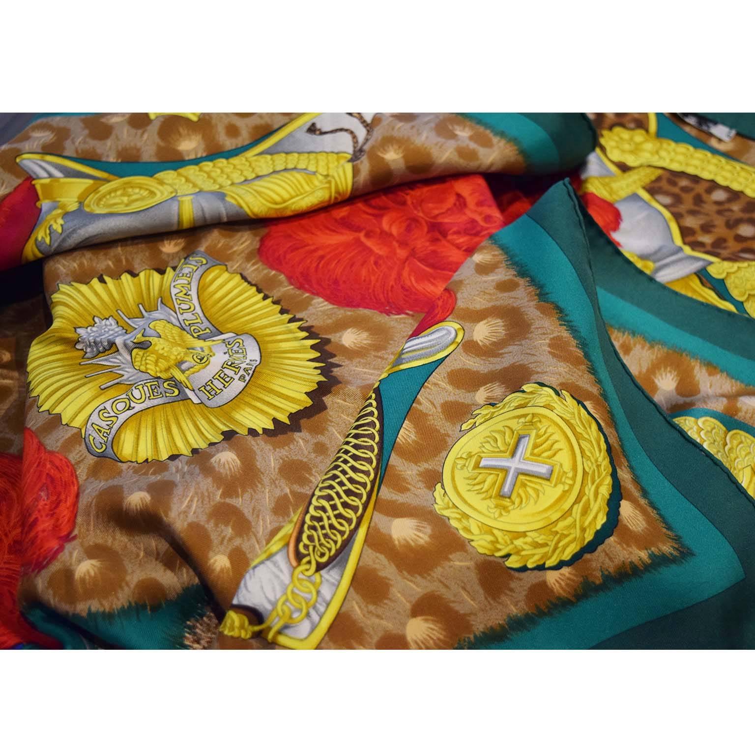 Hermes 'Casques et Plumets' vintage scarf. 100% Silk. Made in France. Green, red, brown, blue & gold shades. Designed by Julia Abadie for Hermes in 1989. No box.

Details:
Creator: Julia Abadie for Hermes
Place of origin: France
Date of