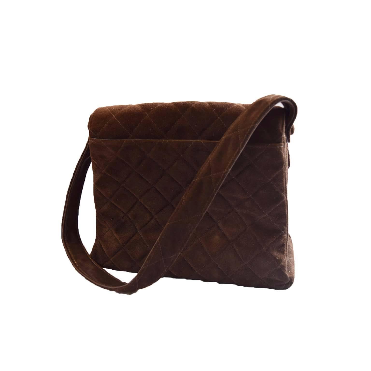 Chanel vintage brown suede handbag with flap & shoulder strap. Serial no. 5109878. Soft suede with diamond quilted pattern with gold hardware. Flat base. 2 main interior compartments as well as a smaller side pocket & one zippered compartment. Comes