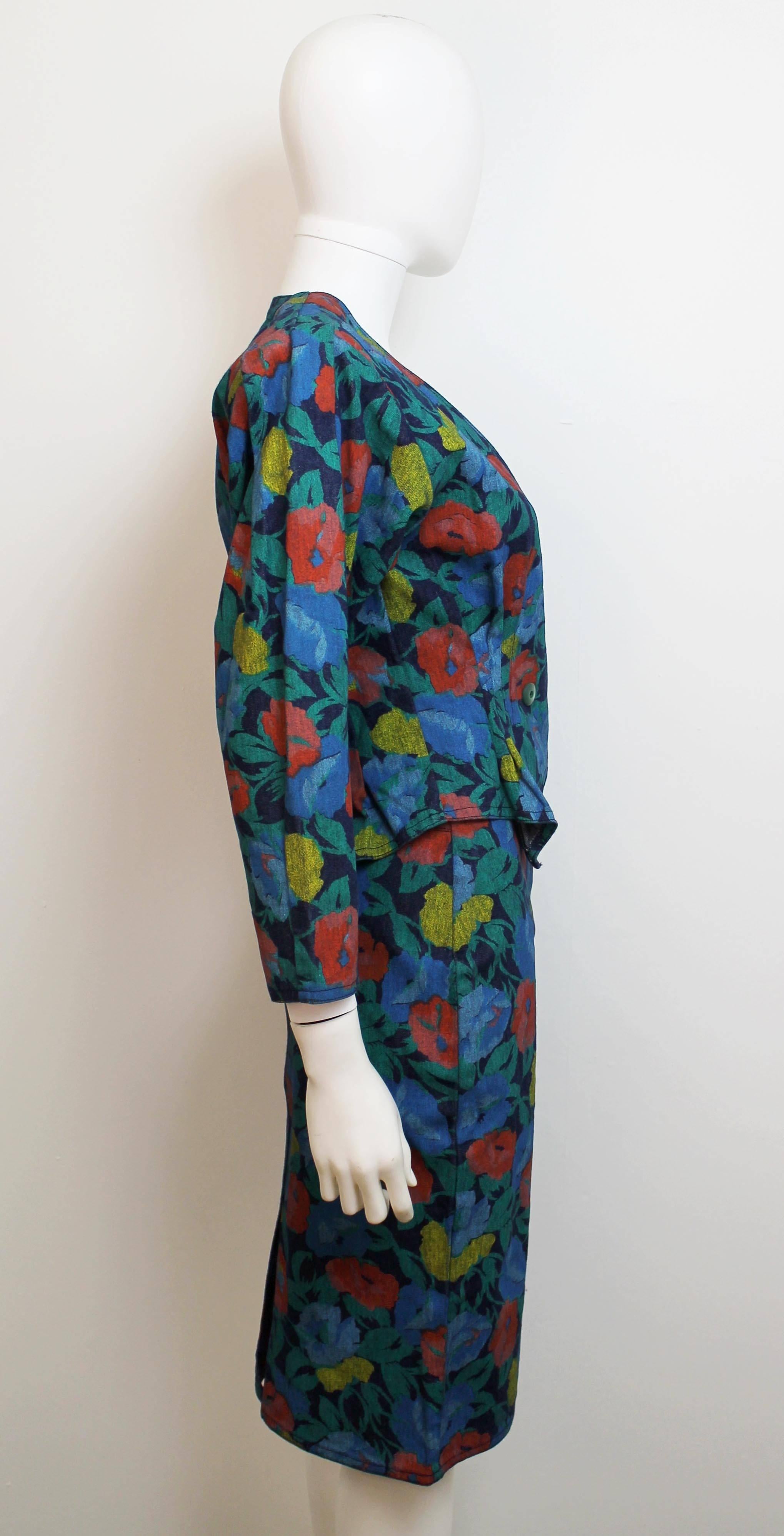 Vintage 1980's floral skirt suit from John Galliano. Includes a form fitting jacket and pencil skirt, with a leg of mutton sleeve. The material is quite stretchy and would flatter many different silhouettes.