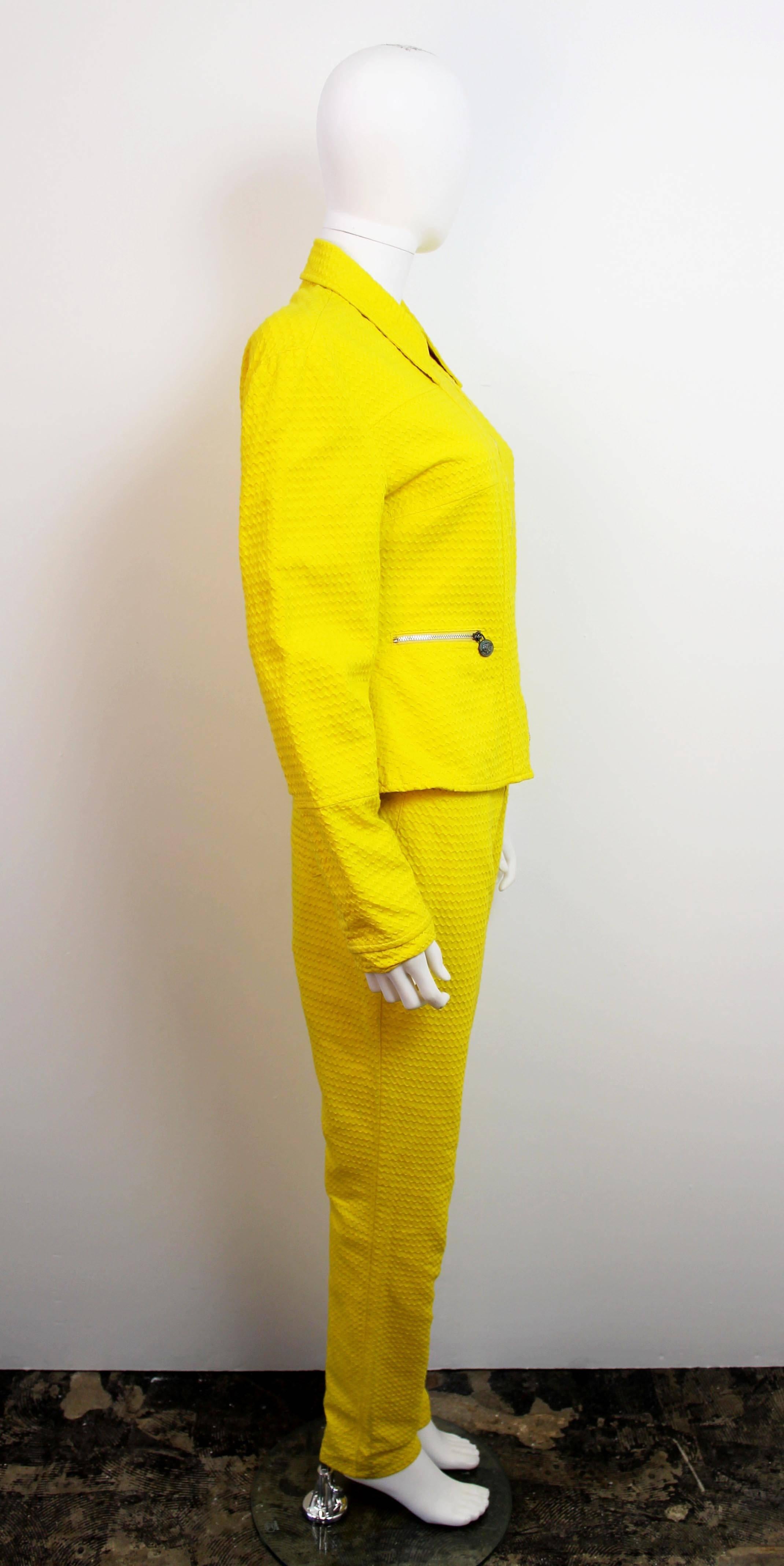 Vintage 1990's Versace Jeans Couture yellow two-piece suit. Features a zig-zag printed cotton motif and a 70's inspired shape. Has medusa head zipper tabs.