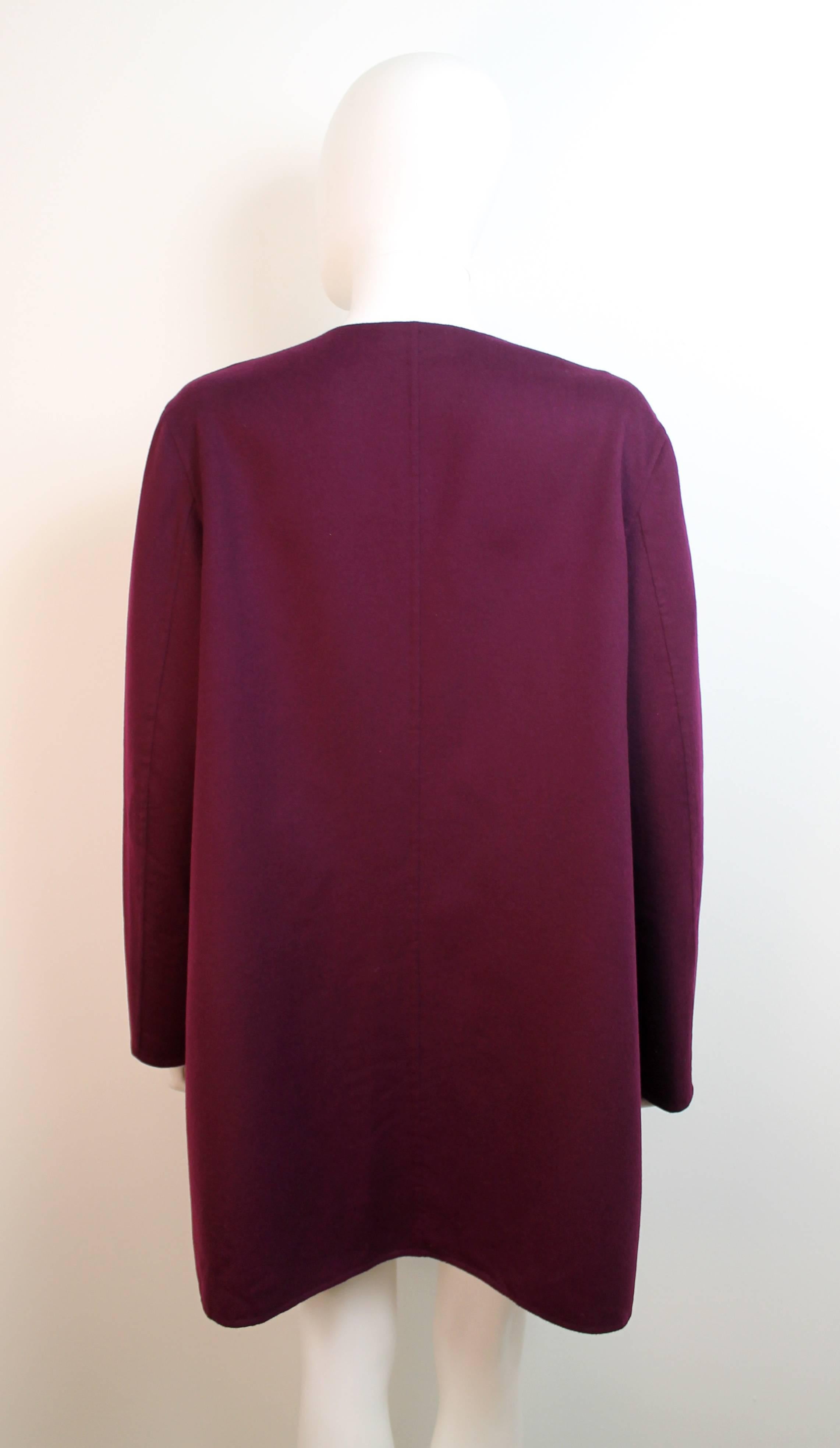 Beautiful purple coat by Jil Sander. The coat is extremely soft and features a round collar and no closures,