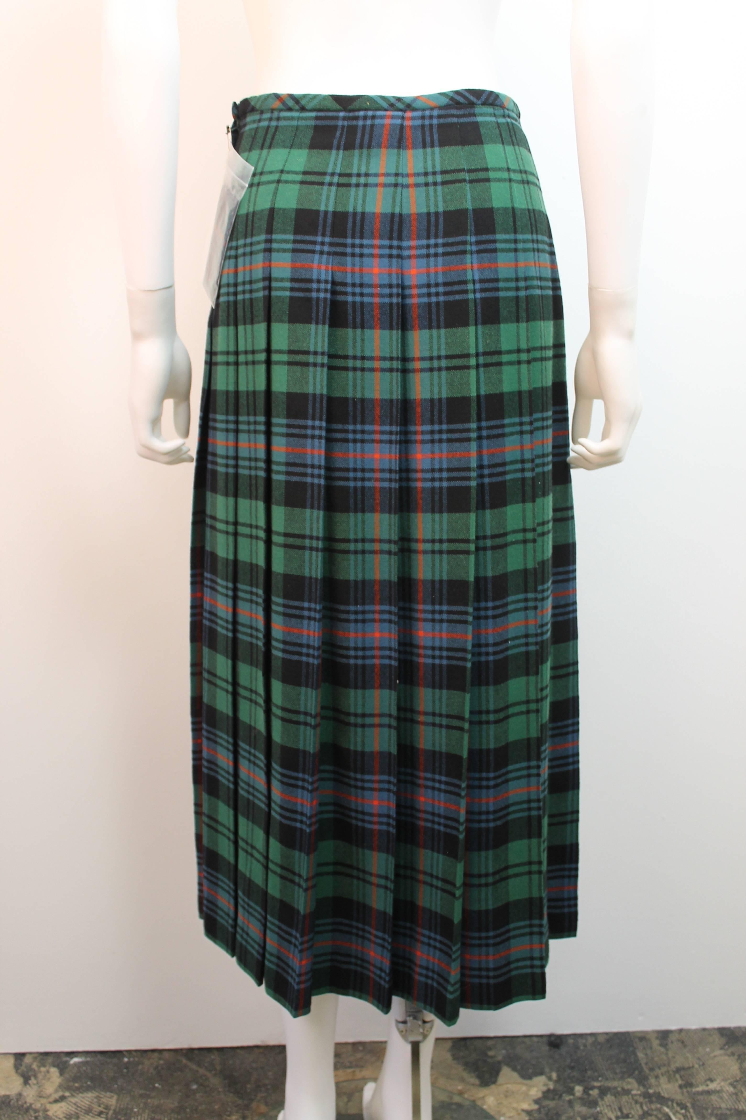 Classic green plaid skirt by Comme des Garcons Robe de Chambre. Features a thin waistband and pleating all the way around. Closes with a side zipper.