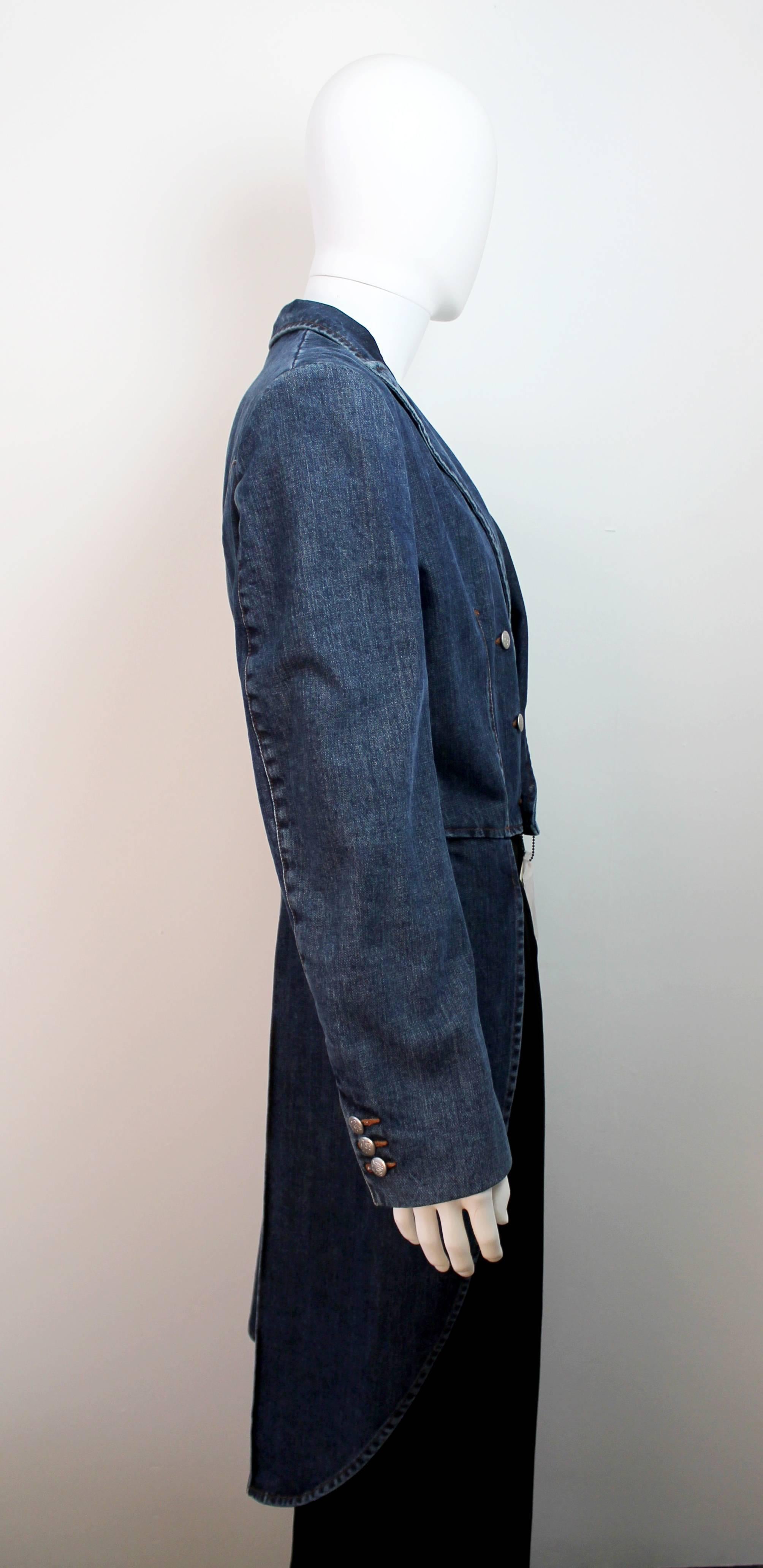 Fantastic denim tailcoat by Jean Paul Gaultier Jeans. The front is double breasted with silver metal buttons and the back has exaggerated long tails that hang down to behind the knee. The coat is brand new with tags and has never been worn.
