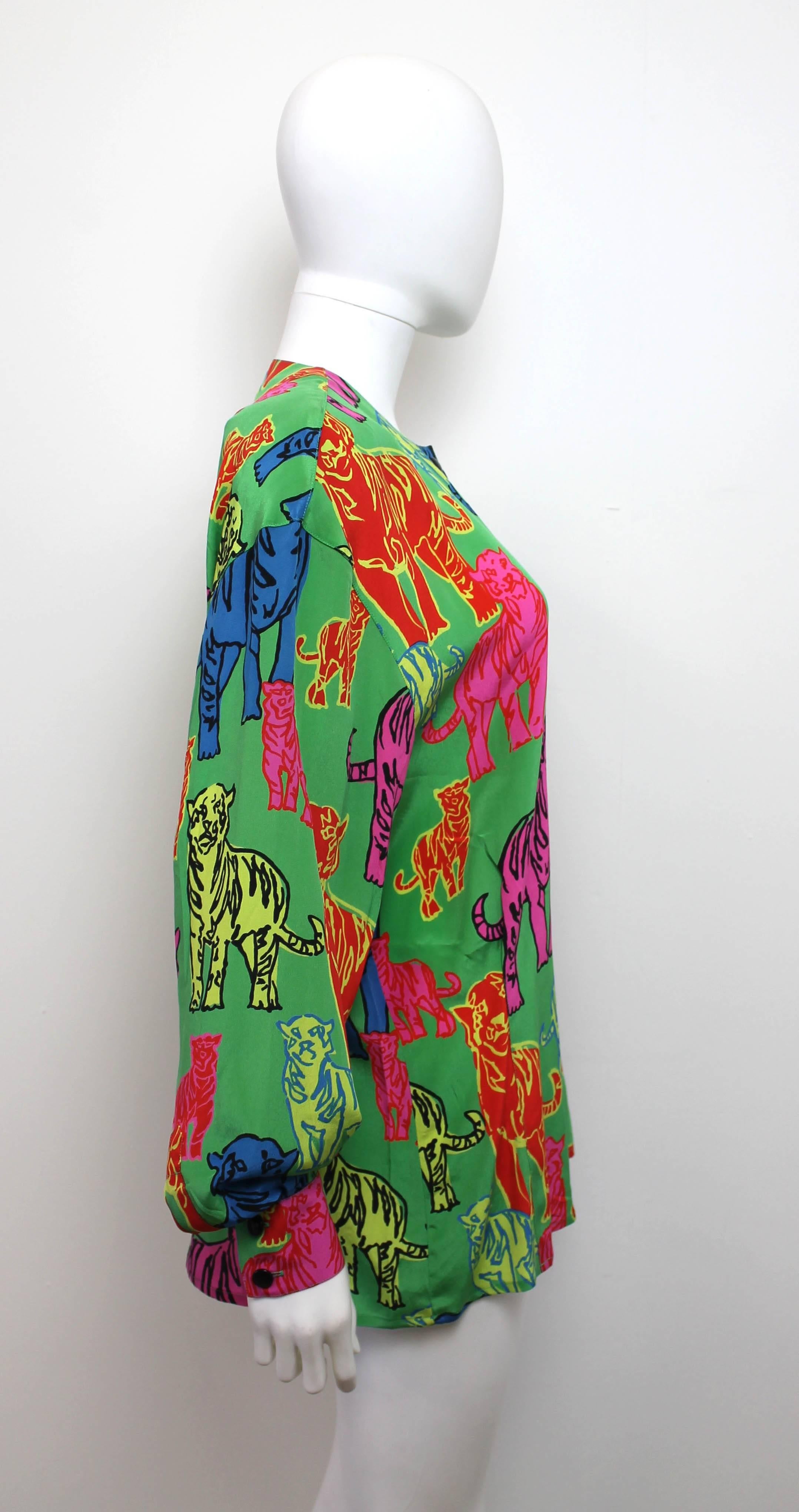 Vibrant and playful shirt by Escada from the late 1980's. The collarless shirt features a cartoon-like multi-color tiger motif. Has small shoulder pads.
