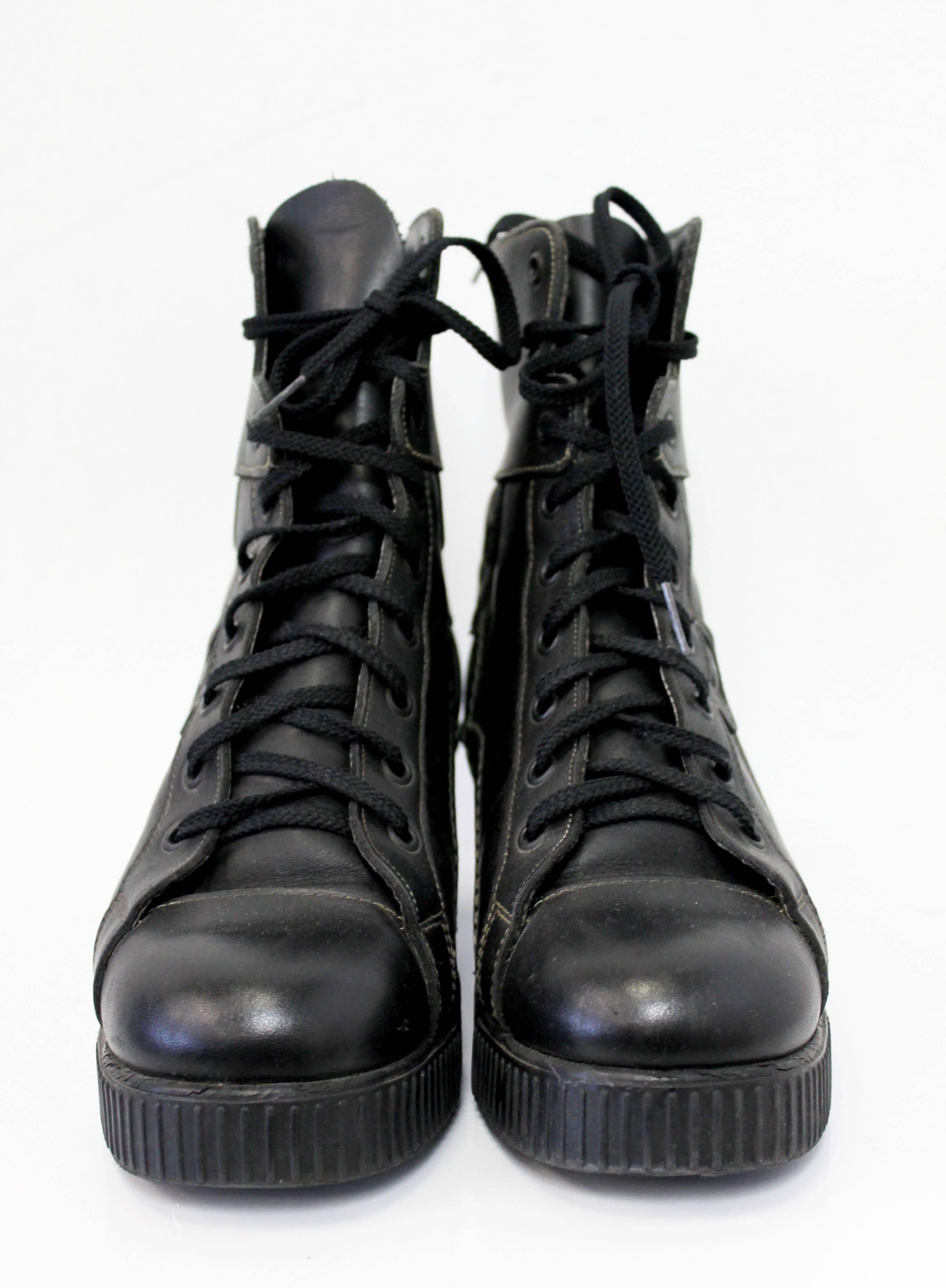 Fantastic black leather boots by Junior Gaultier. The boots feature top-stitched detailing along the sides and laces all the way up to the ankle. Very comfortable to wear.